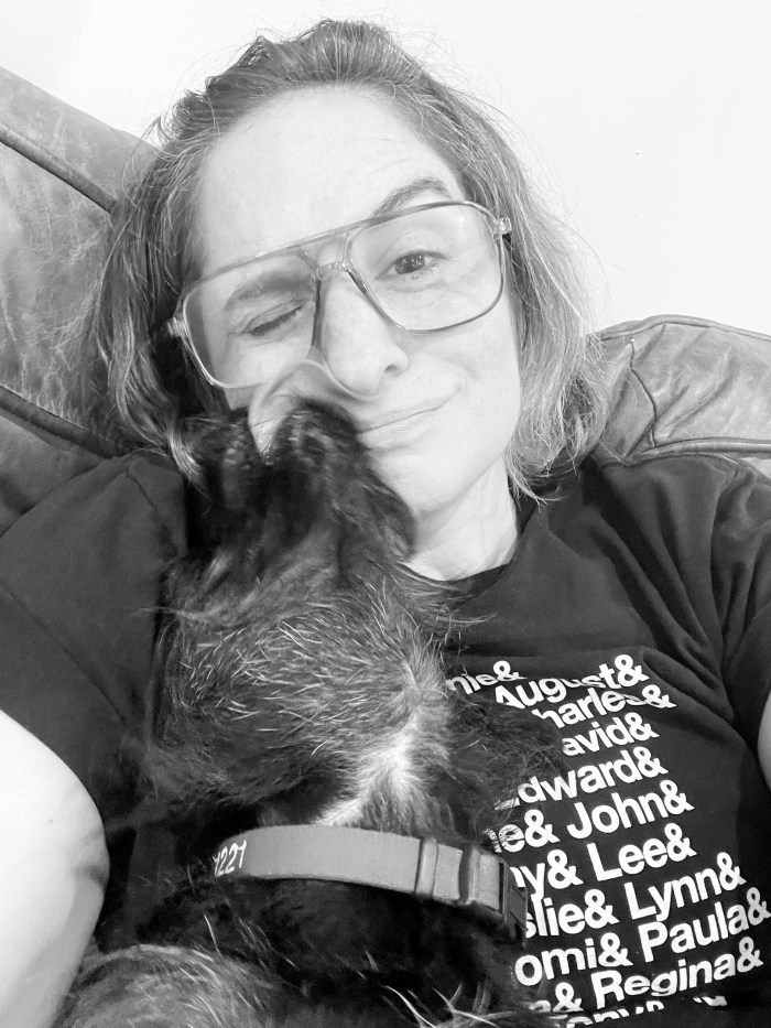 Alix's face being licked by a very precocious wire-haired dachshund/terrier mix